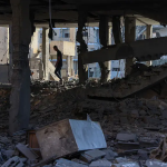 In the rubble of a house destroyed by an Israeli strike in Beit Lahia, in the northern Gaza Strip, on 23 July.